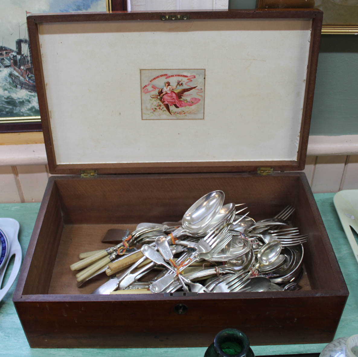 A mahogany box containing silver plated cutlery