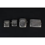 Three silver vestas and a silver match box holder