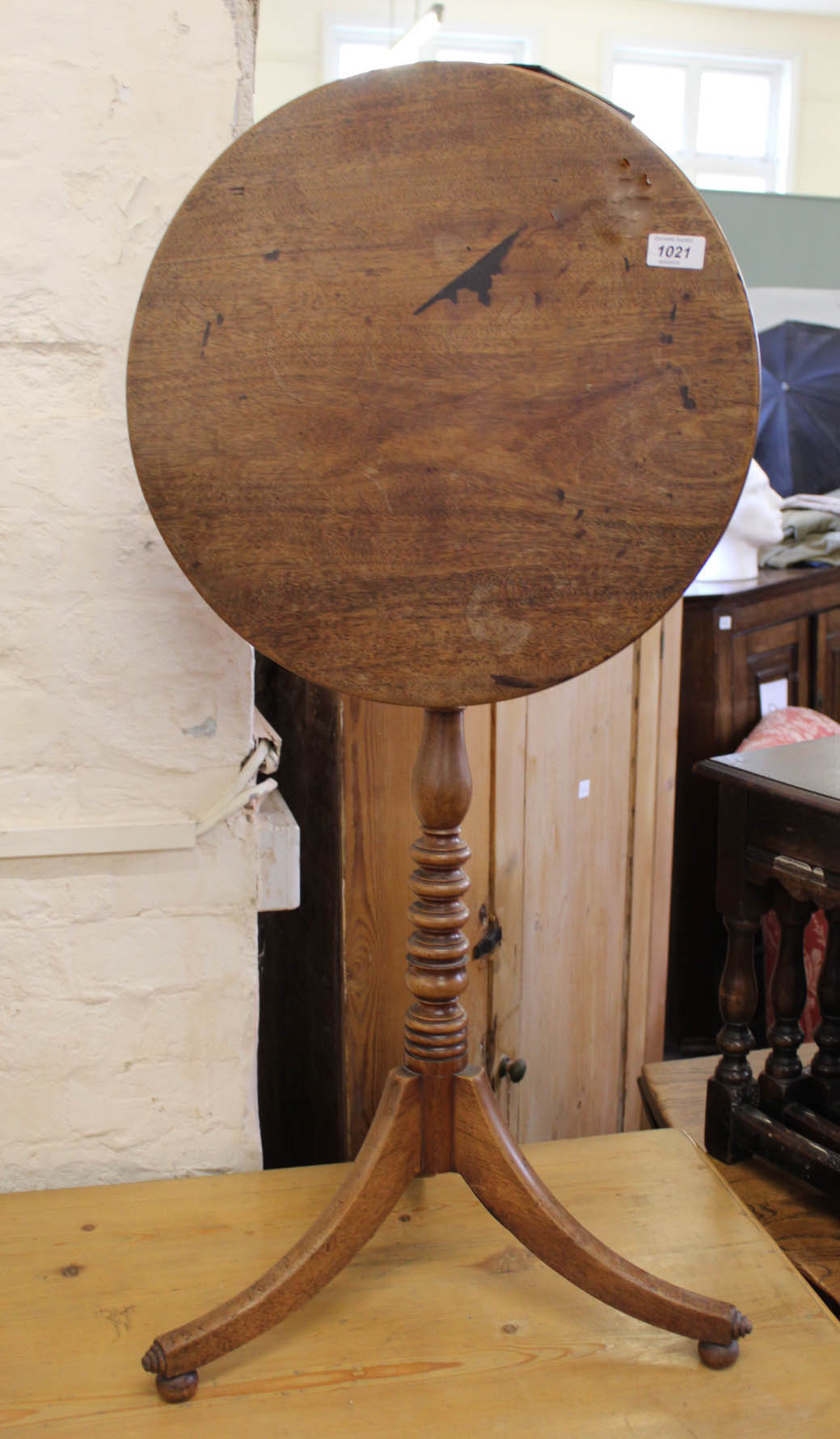 A Victorian mahogany circular tilt top table on tripod base