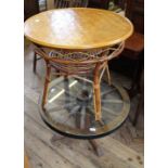 A circular bamboo table and a wagon wheel glass top coffee table