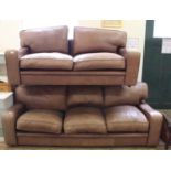 A substantial brown leather three seater sofa and a matching two seater sofa