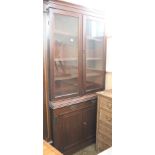 An Edwardian mahogany glazed bookcase cupboard marriage