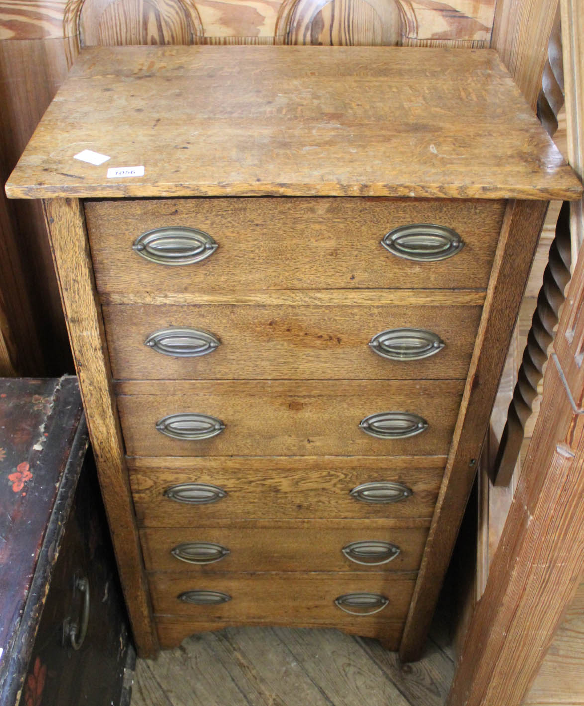 An Edwardian six drawer Wellington chest with original plate handles