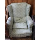 An Edwardian upholstered wingback armchair