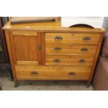 An Edwardian oak sideboard comprising four drawers and a single door cupboard