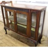 An 1930's shaped front glazed display cabinet