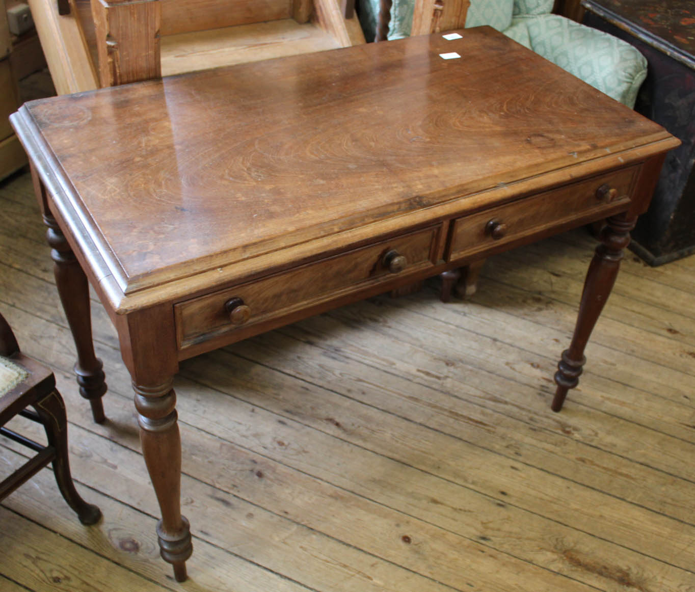 A Victorian walnut French style two drawer writing table on turned legs
