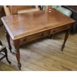 A Victorian walnut French style two drawer writing table on turned legs