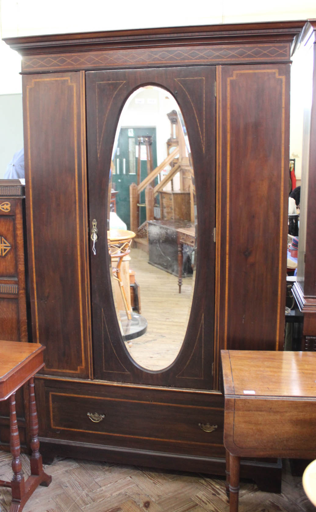 An Edwardian inlaid mahogany mirrored double wardrobe