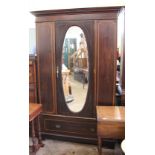 An Edwardian inlaid mahogany mirrored double wardrobe