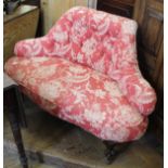 A Victorian kissing chair with button back and floral upholstery