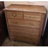 An Edwardian four drawer stripped chest of two short and three long drawers