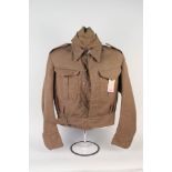 A 1940 patt battle dress blouse dated Feb 1944 with Home Guard shoulder titles and SFK8 arm
