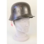 A German WWI era model 1916 steel helmet complete with liner and strap