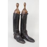 A pair of vintage leather riding boots complete with spurs and a pair of trees (possible Officers