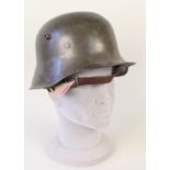 A German WWII (PATTERN) helmet with a liner