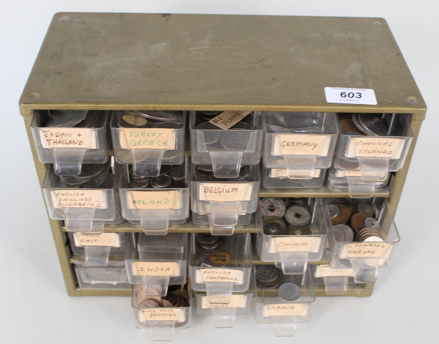 A multi drawer cabinet containing a wide range of world coins,