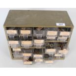 A multi drawer cabinet containing a wide range of world coins,