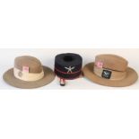 Two Gurkha slouch hats with insignia and a Gurkha 'pill box' by Hobson & Sons London dated 1940