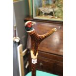 A bespoke hand crafted walking stick with pheasants head and whistle