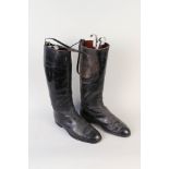 A pair of black riding boots,