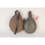 A German WWII era water canteen with a WWI example