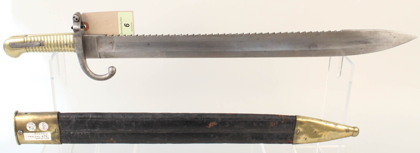 A Belgium model 1868 Pioneer (sawback) bayonet with brass mounted leather scabbard