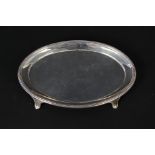 A Victorian silver oval teapot stand on four feet with ribbed border