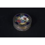 A continental 800 grade silver pill pot with extensive engraved decoration all over and enamelled