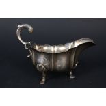 A silver wavy rim sauce boat on three hoof feet by Lambert and Co,