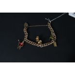 A 9ct gold charm bracelet with four 9ct gold charms including enamelled bag pipes,