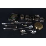 A quantity of silver souvenir spoons, silver napkin rings, a pair of silver plated sugar tongs,