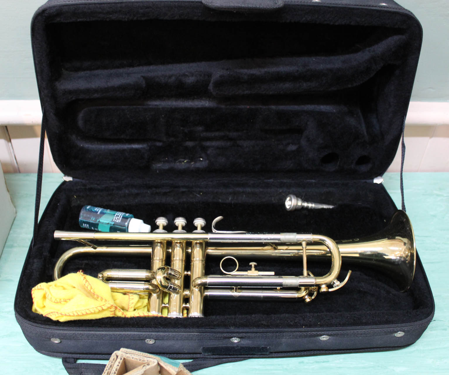 A cased brass trumpet marked B & M Champion