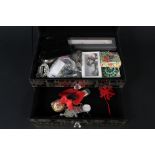 A mirrored jewellery box with costume jewellery contents including rings, earrings,