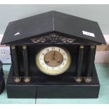 A black marble striking mantel clock