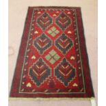 A Persian red ground rug,