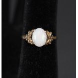 A 9ct gold opal ring with ornate setting,