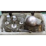 A basket containing silver plated six bottle cruet plus other silver plated wares