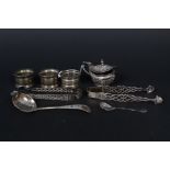 A mixed lot including three various silver napkin rings,