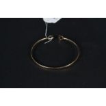 A 9ct gold bangle with double heart decoration