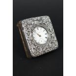 A silver fronted pocket watch holder with pierced and embossed decoration with a silver pocket
