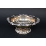 A large American sterling silver bowl on flared base with raised floral decoration to base and top