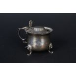 A silver mustard pot with ribbed border,