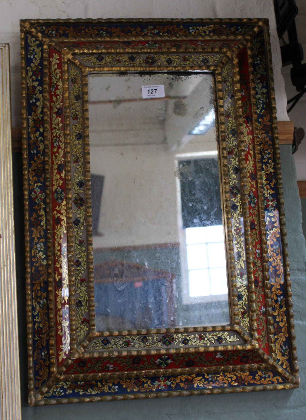 A Venetian mirror with gilt and floral glass panels