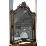 A shaped carved giltwood wall mirror