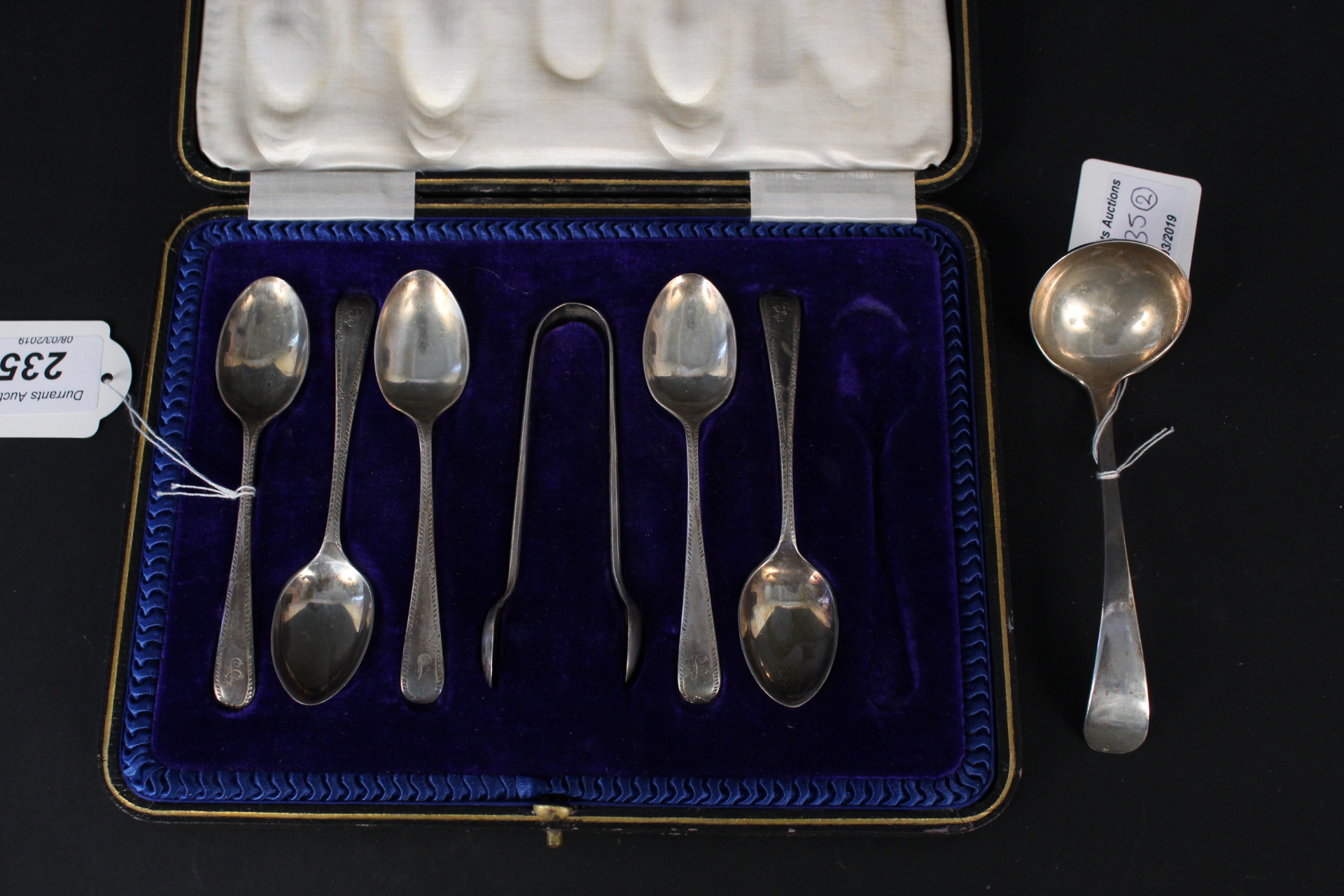 A boxed set of five (of six) teaspoons and matching sugar nips together with a silver sauce ladle