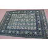 A machine made green ground Persian pattern rug,