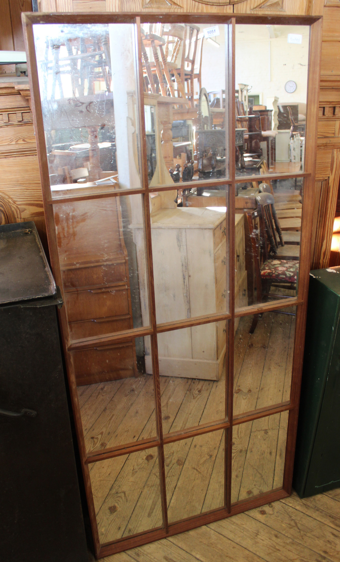 A large oak framed mirror in the style of a French window