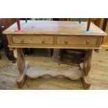 A Victorian pine two drawer writing table