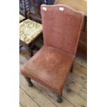 An Edwardian upholstered high back armchair